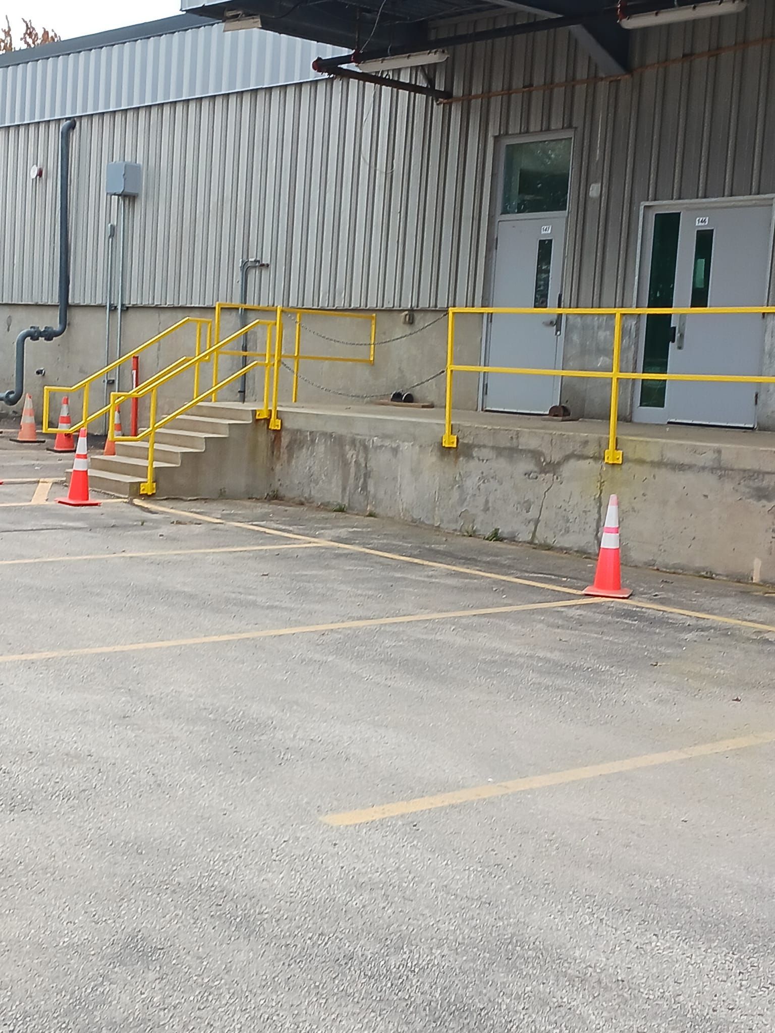 A warehouse with a yellow railing and stairs