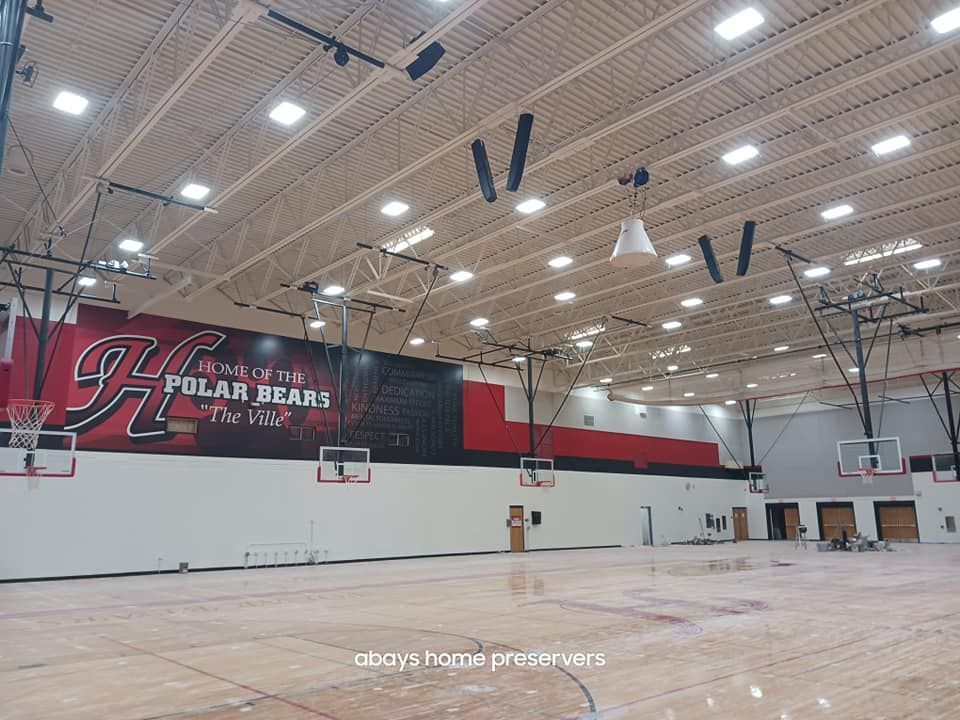 A large indoor basketball court with a polar bears banner on the wall.