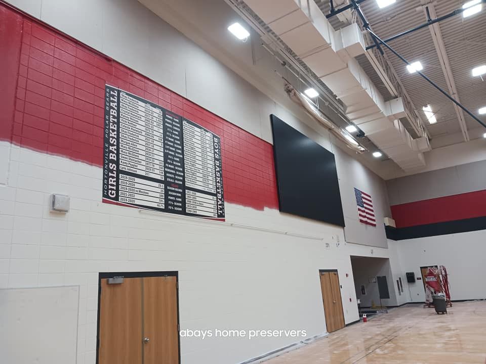A gym with a sign on the wall that says girls basketball