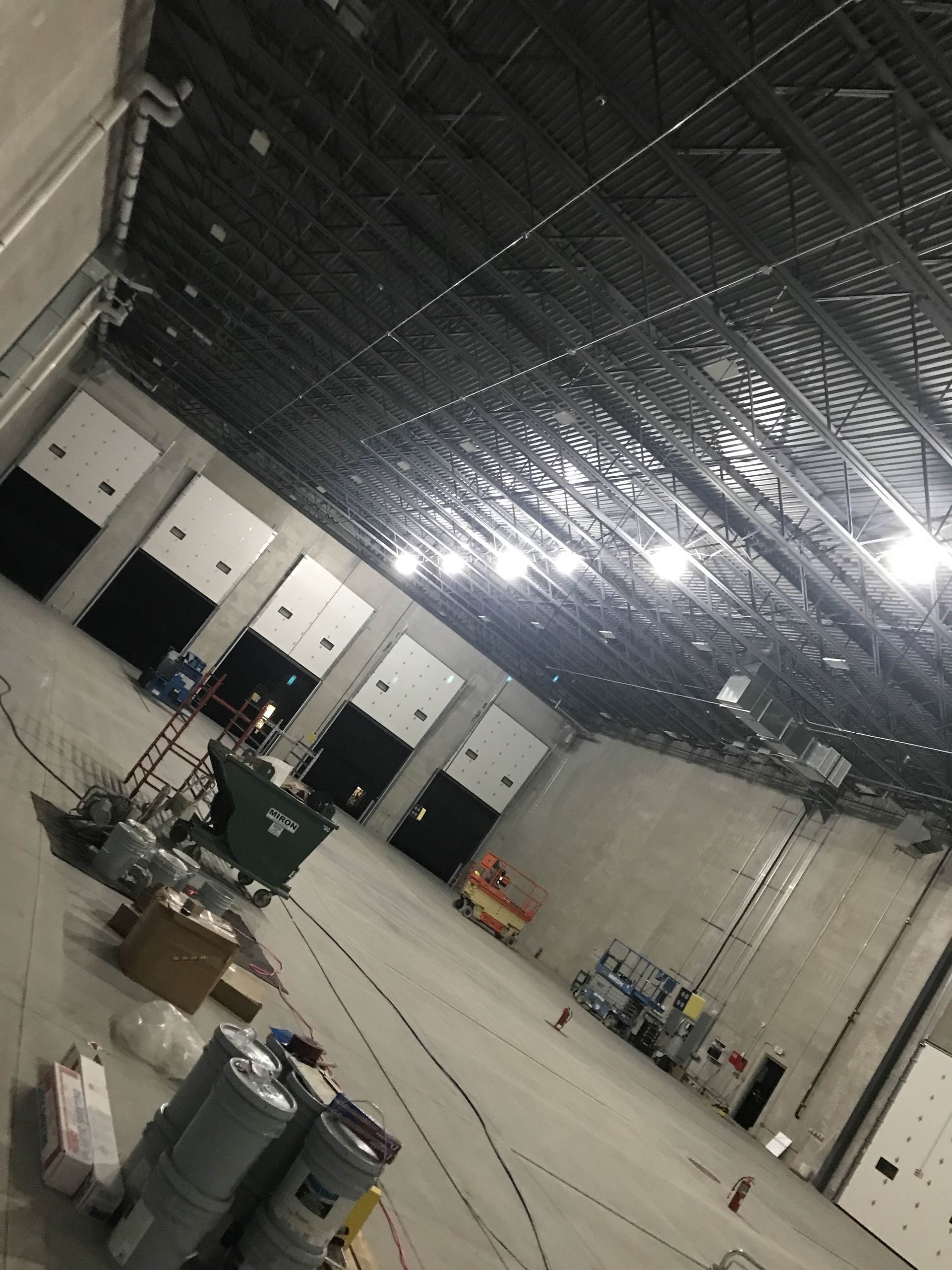 A large empty warehouse with a lot of doors