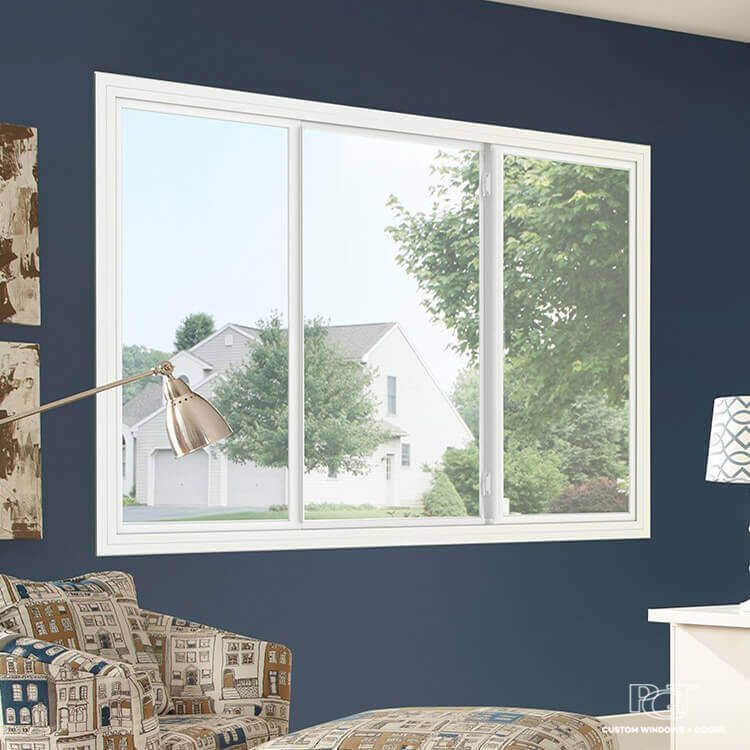 White-framed sliding window looking out onto a sunny yard, set against a dark blue wall. White-framed sliding window looking out onto a sunny yard, set against a dark blue wall.