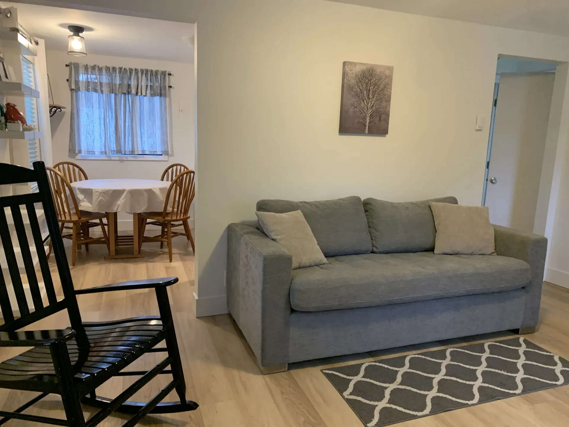 A living room with a rocking chair and a couch