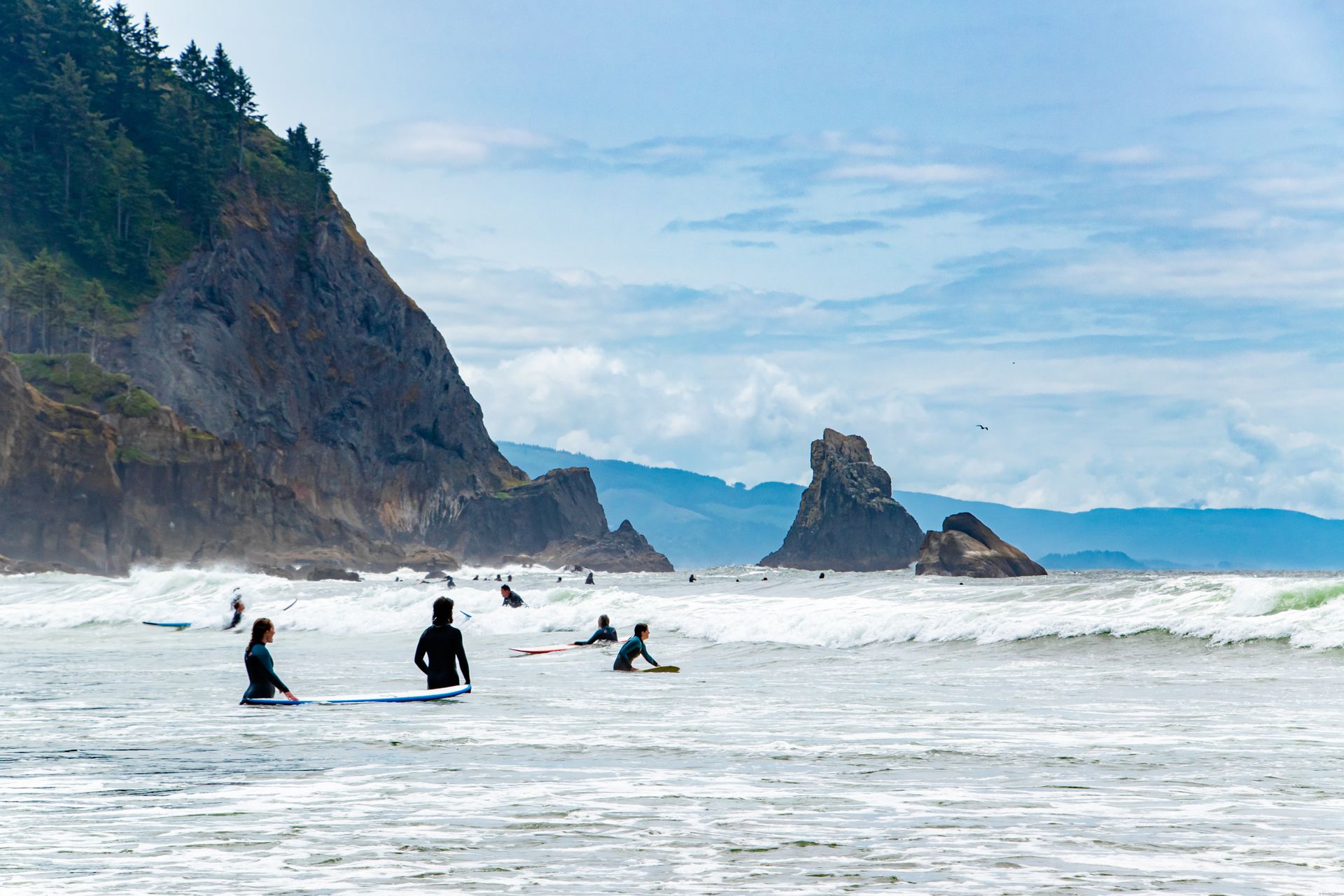 A group of people are riding waves on a beach.