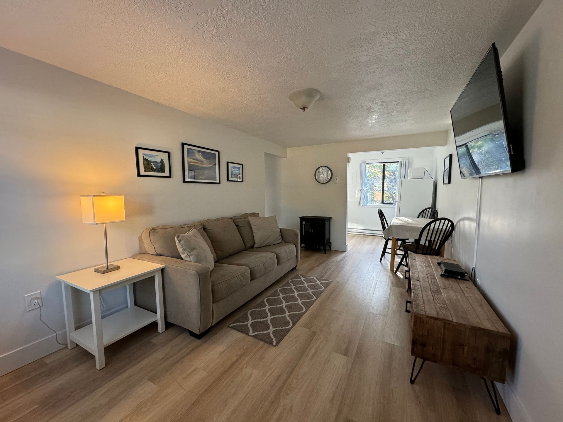 A living room with a couch , table and television.
