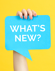 Hand holding a blue speech bubble with