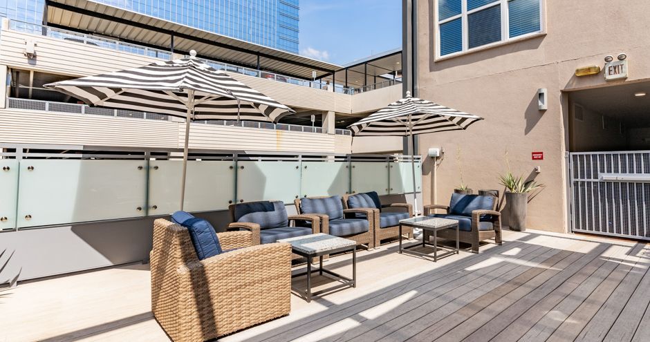 The Standard at Domain Northside outdoor lounge with seating and umbrella in Austin, TX.