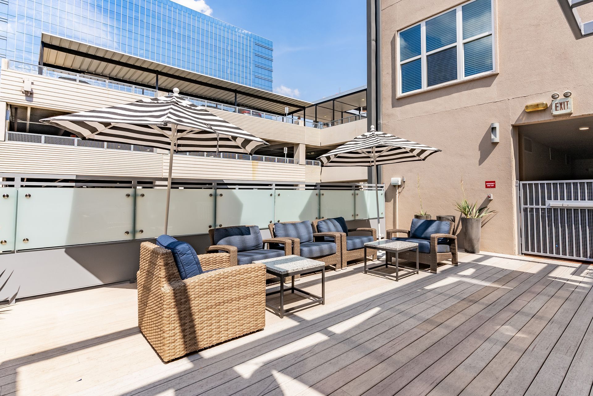 Beautiful poolside outdoor lounge with seating area and umbrellas The Standard at Domain, offers apartments by The Domain Austin.