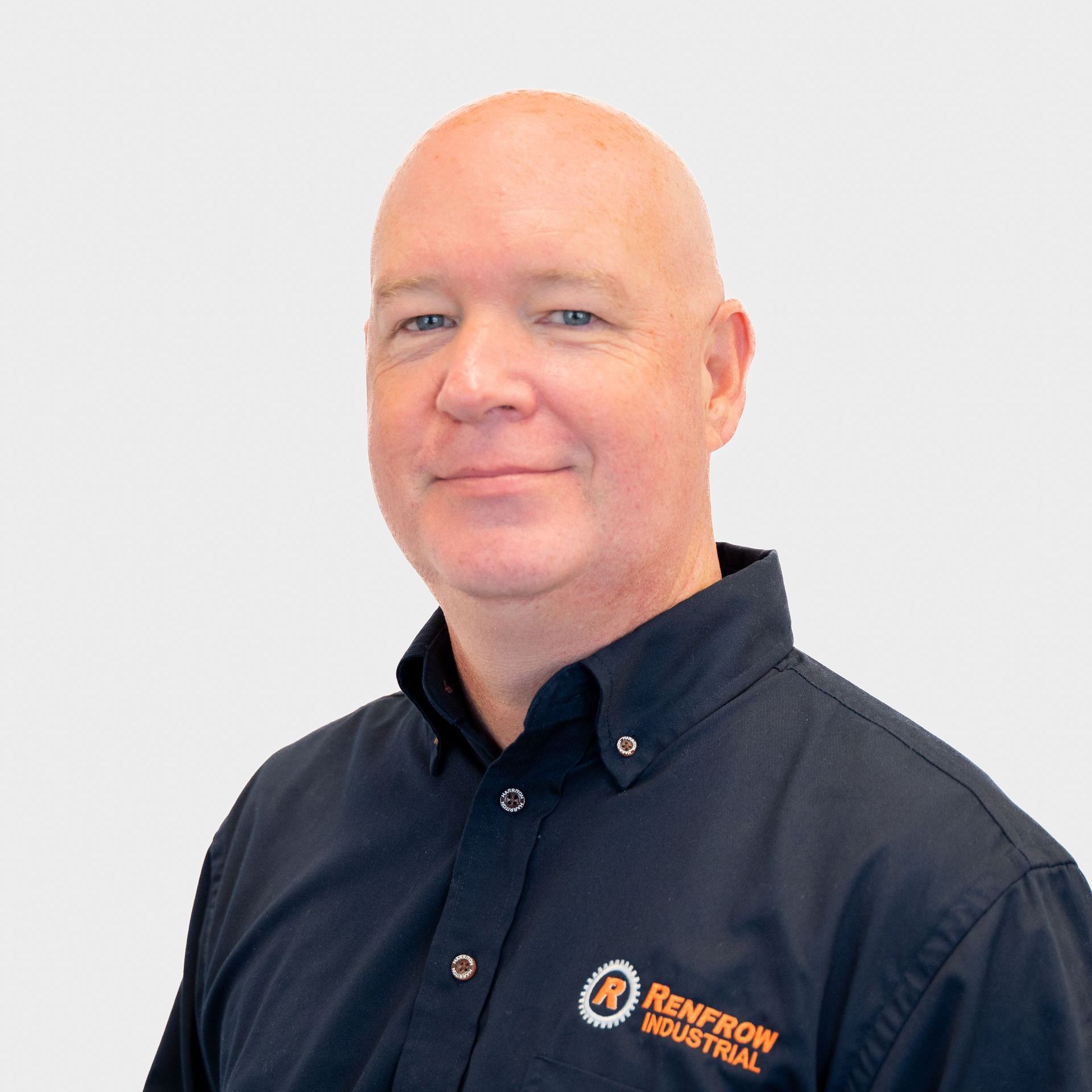A bald man in a navy shirt with