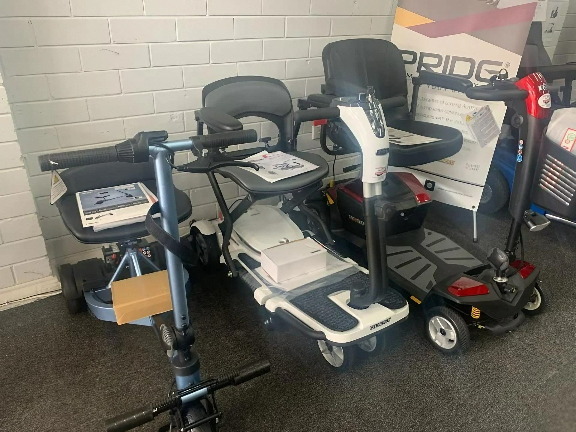 A row of mobility scooters displayed in a room — Toukley World of Bikes In Toukley, NSW