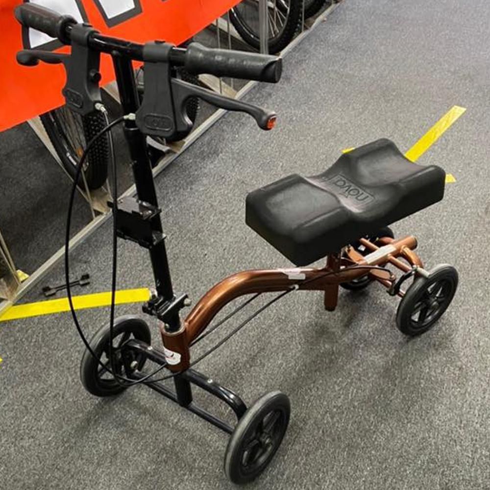 A Knee Walker Is Sitting on The Floor in A Store — Toukley World of Bikes In Toukley, NSW