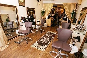 A hair salon with a lot of chairs and mirrors.