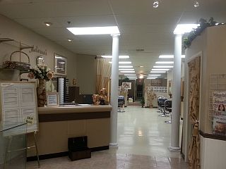 A large room with a reception desk in the middle of it.