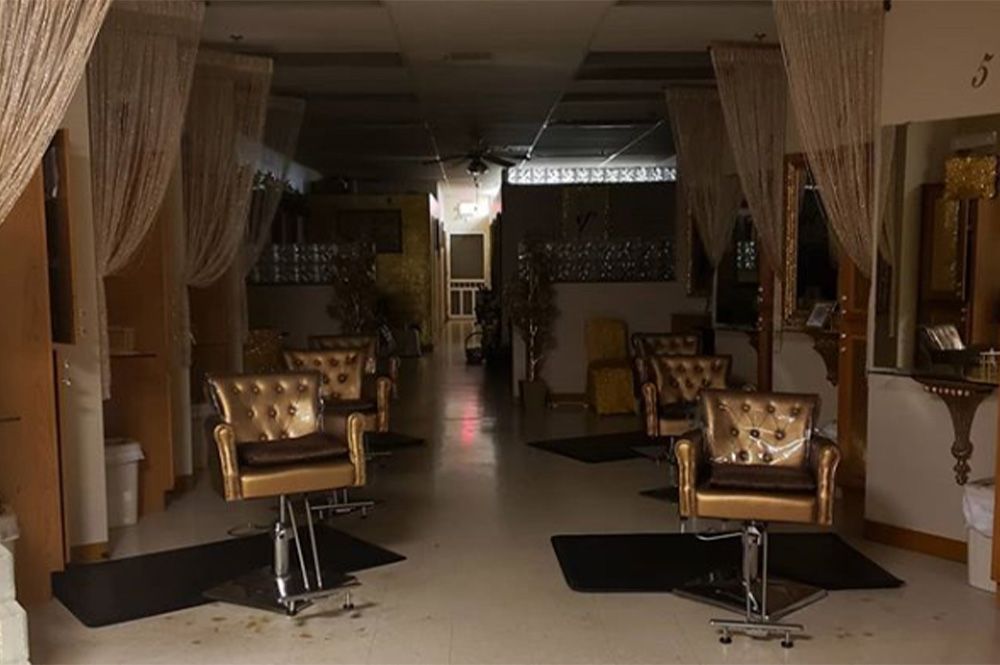 A salon with a lot of chairs and curtains.