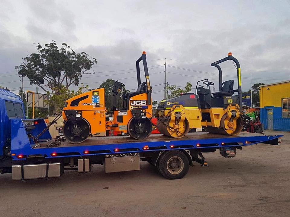 Two Rollers Are Sitting on Top of a Blue Tow Truck — Coastwide Towing & Transport In Berkeley Vale, NSW