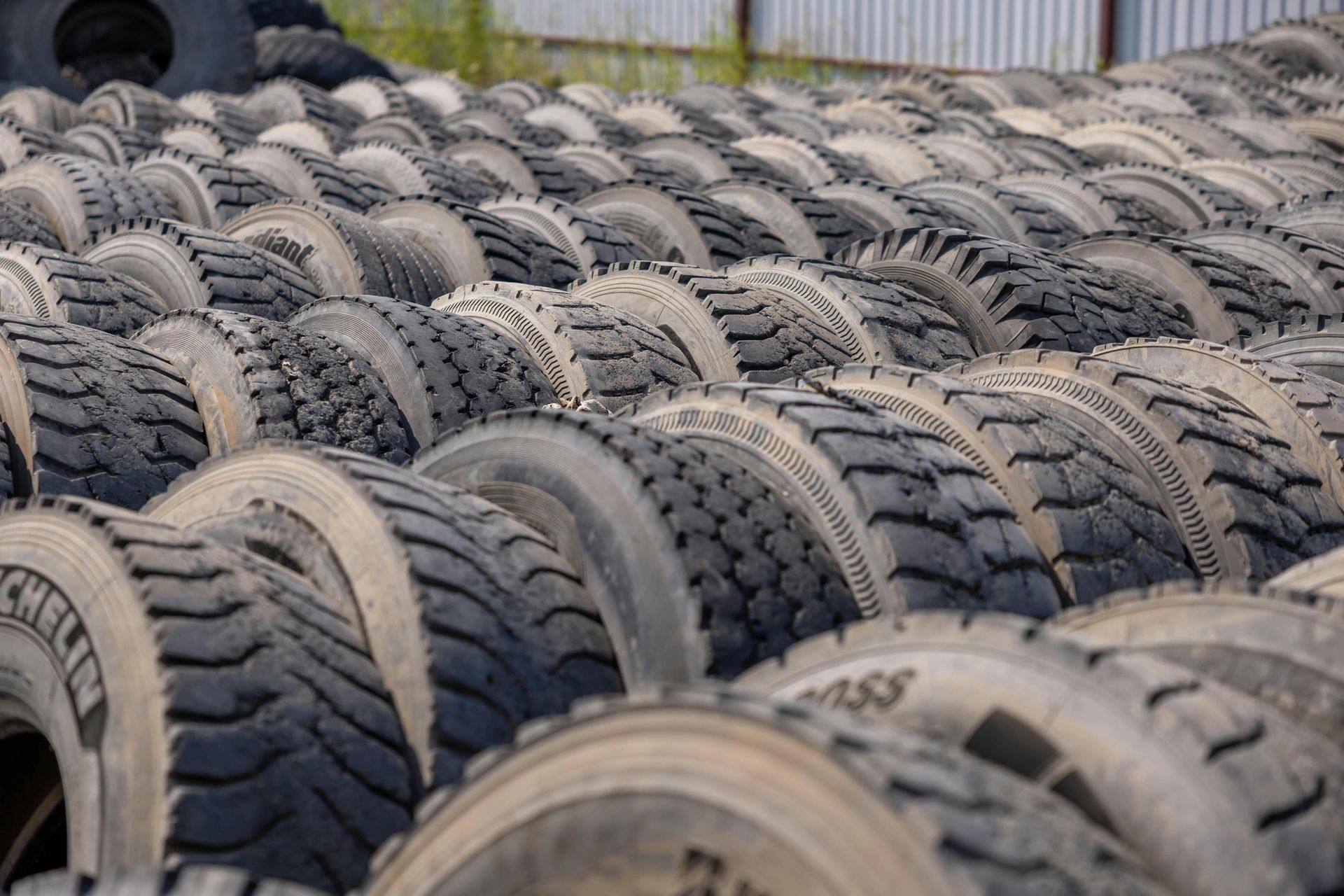 Stacked Used Tires Outdoors in Rows, Showing Worn Tread Patterns and Black Rubber — Bay City A1 Tyres in North Geelong, VIC