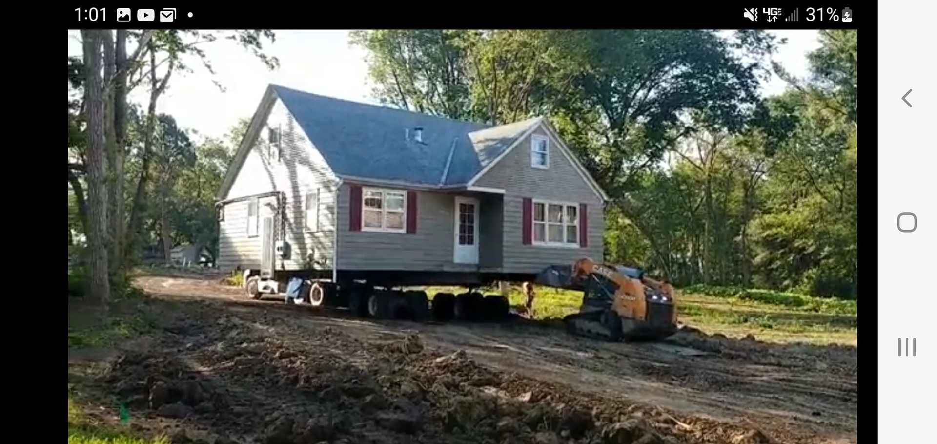 A house is being moved to a new location on a trailer.