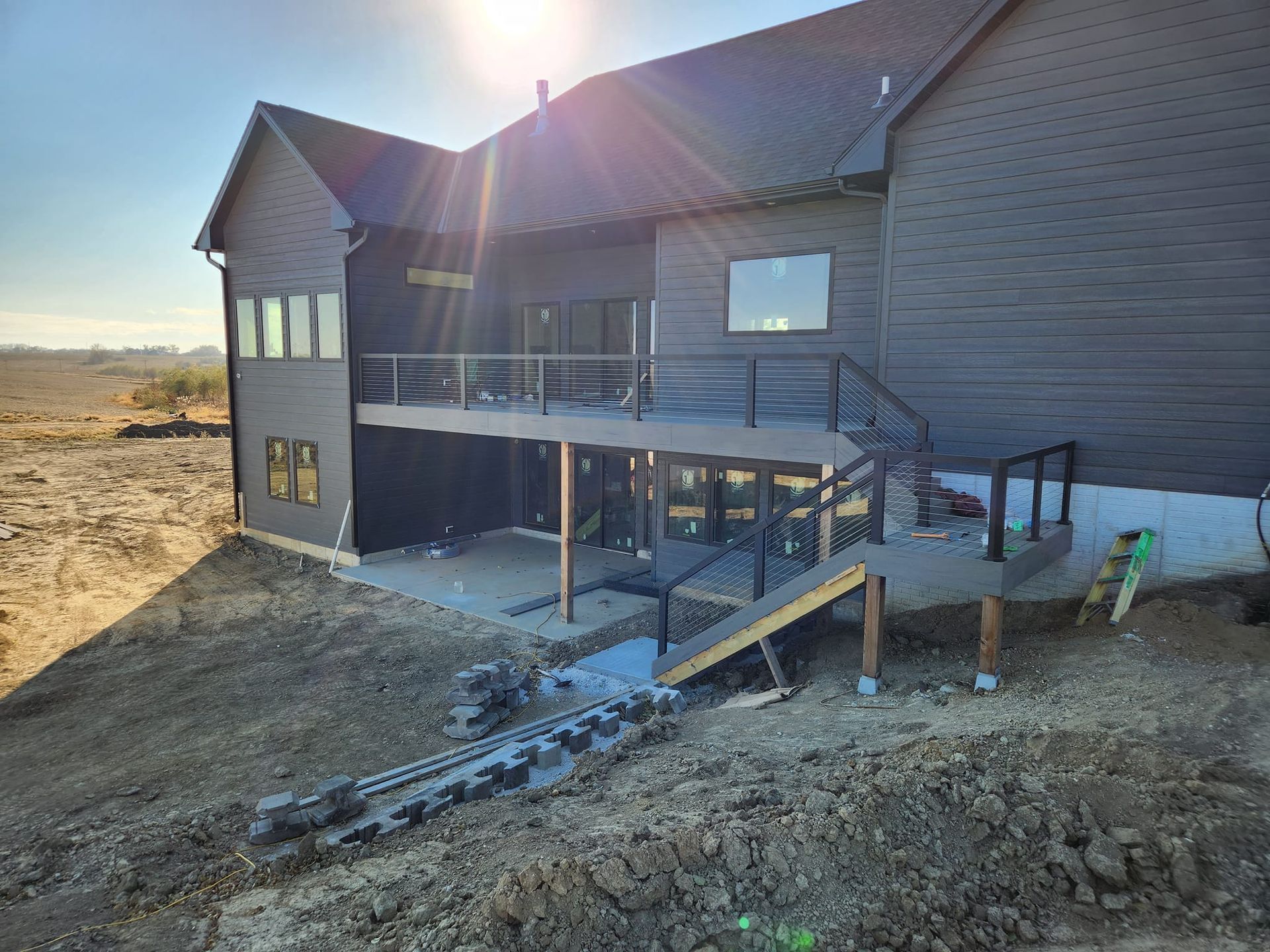 The back of a house with a large deck and stairs. Independence Built Custom Home Builder in Nebraska