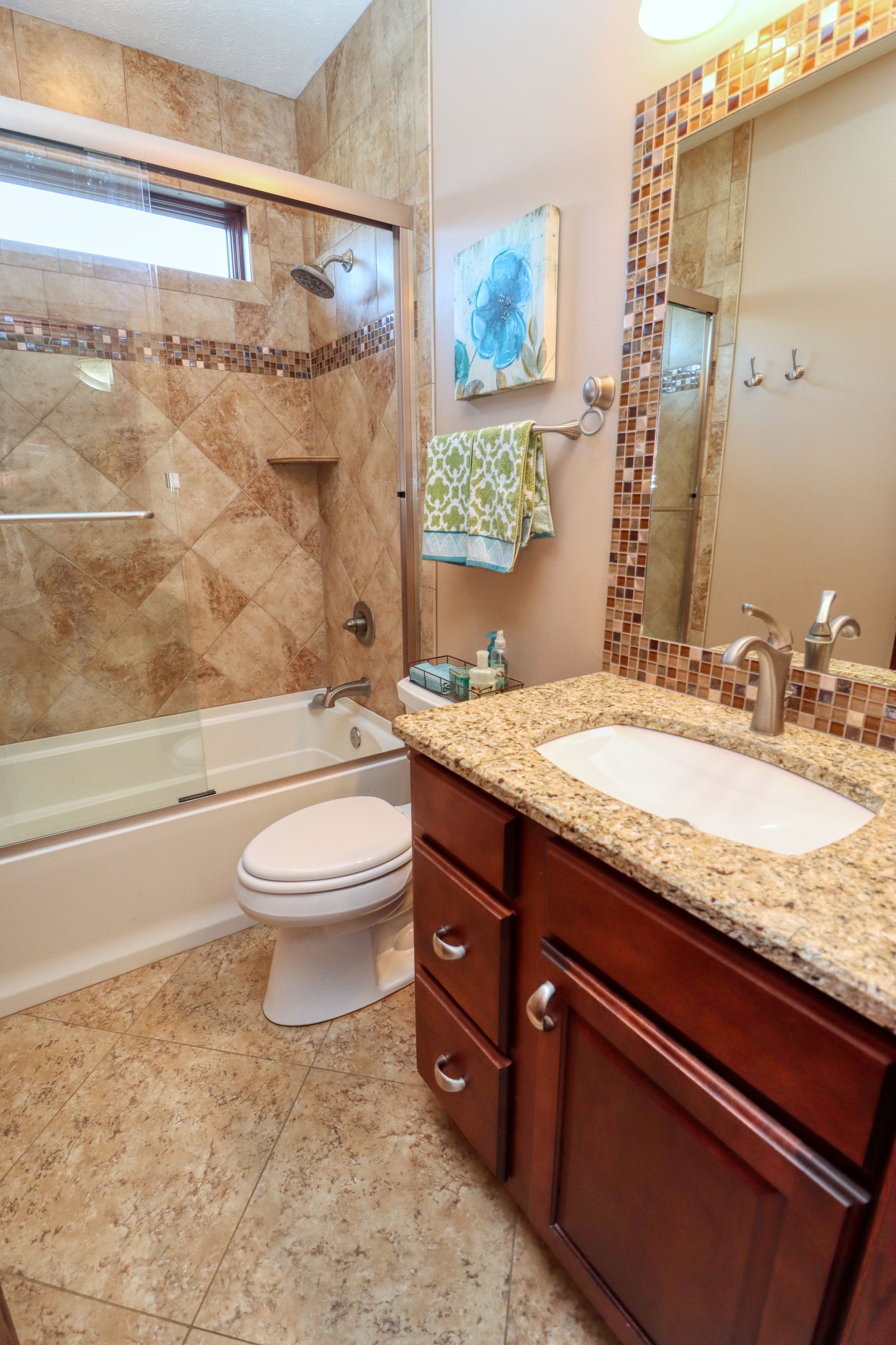 A bathroom with a toilet , sink and bathtub