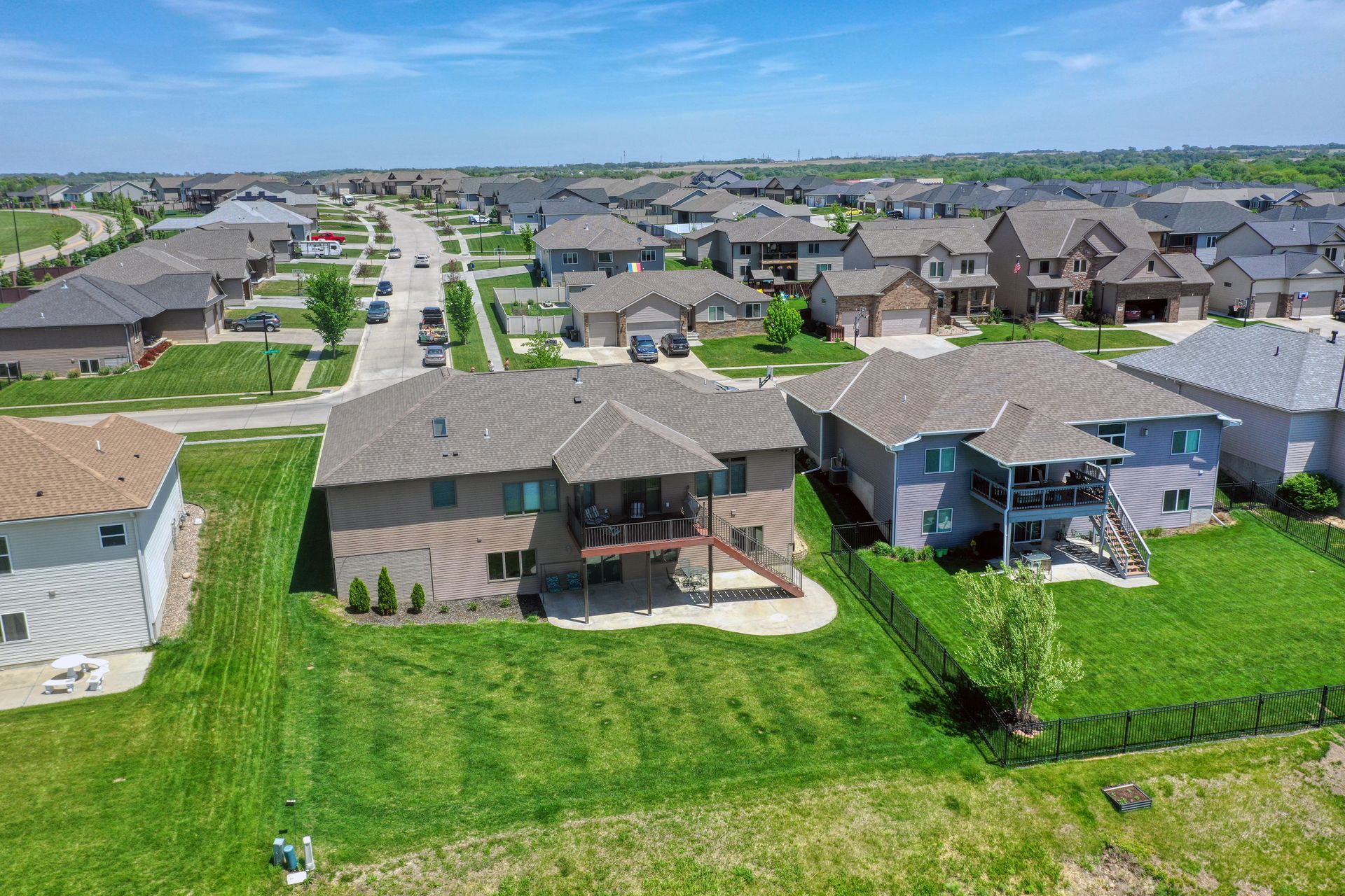 An aerial view of a residential area with lots of houses and grass.