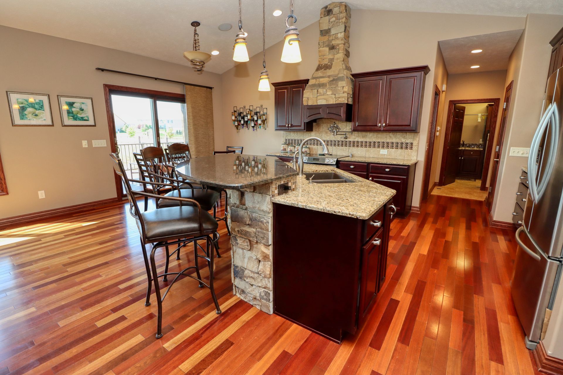 A kitchen with hardwood floors and granite counter tops