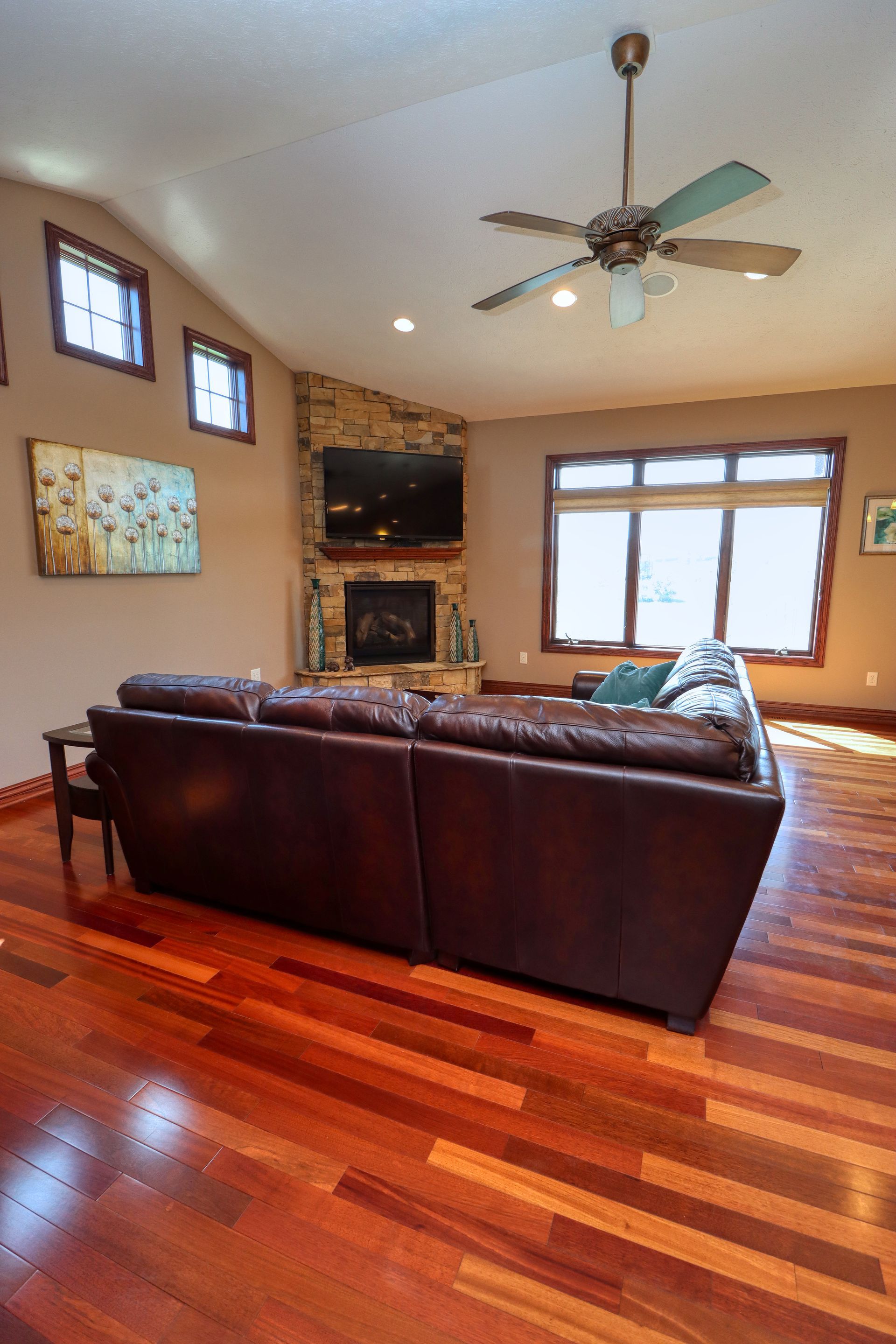 A living room with hardwood floors and a ceiling fan