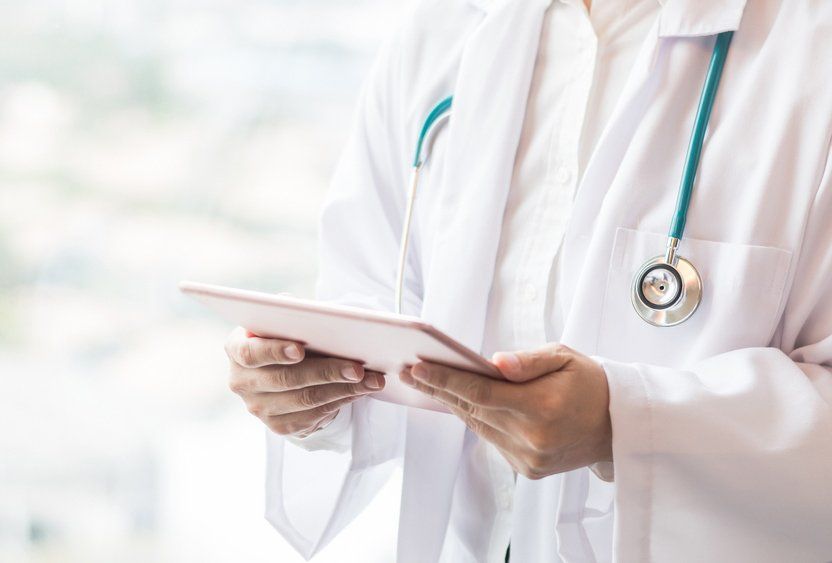 Medical Doctor Consulting Patient's Using Digital Tablet — Deception Bay Doctors In Deception Bay, QLD