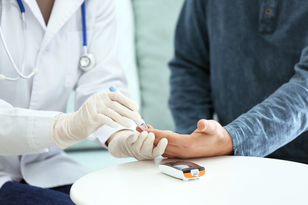 Doctor Taking Sample Of Diabetic Patient's Blood Using Lancet Pen — Deception Bay Doctors In Deception Bay, QLD