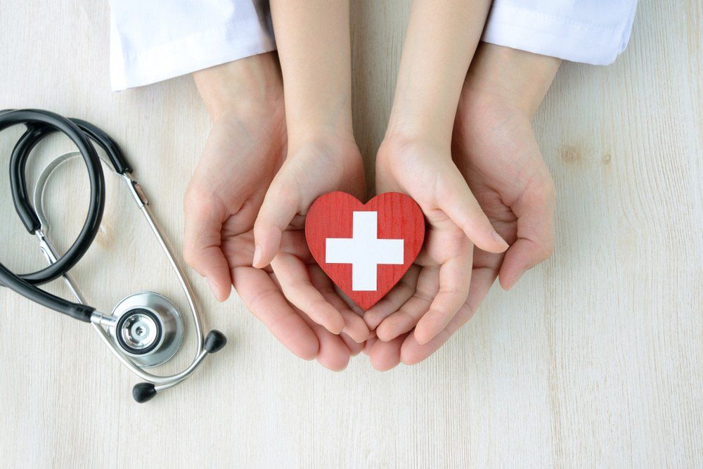Adult And Children Hands With Stethoscope and Love Heart — Deception Bay Doctors In Deception Bay, QLD