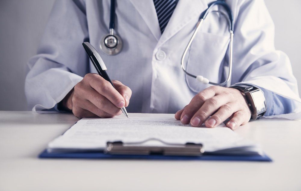Doctor Writing In Medical Office — Deception Bay Doctors In Deception Bay, QLD