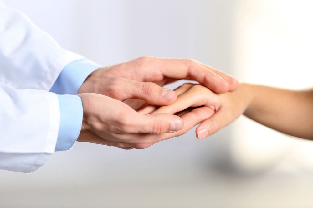 Hand Of Medical Doctor Carefully Holding Patient's Hands — Deception Bay Doctors In Deception Bay, QLD