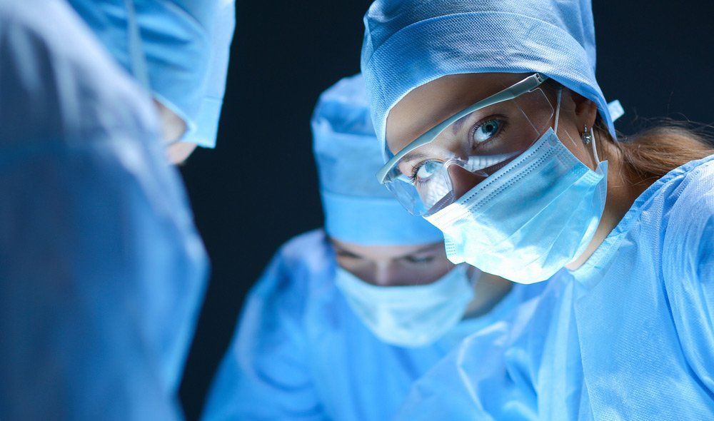 Team Surgeon At Work On Operating In Hospital — Deception Bay Doctors In Deception Bay, QLD