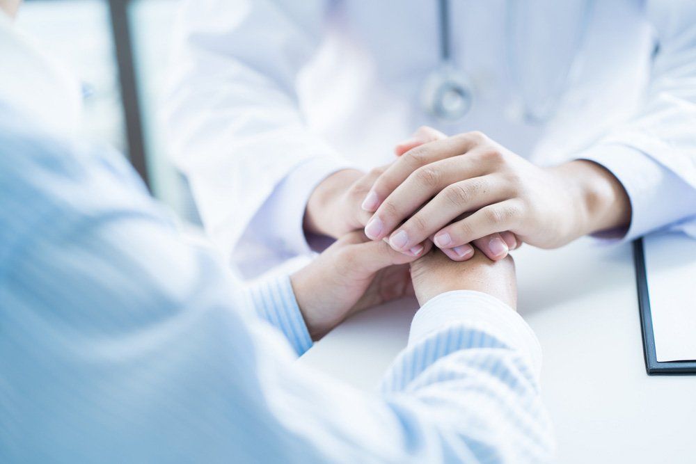 Male Doctor Comforting Patient At Consulting Room — Deception Bay Doctors In Deception Bay, QLD