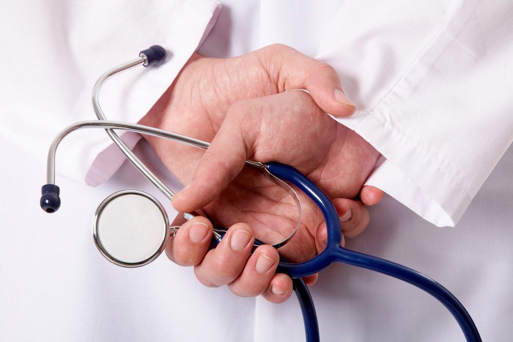 Hands Of Practitioner With Stethoscope — Deception Bay Doctors In Deception Bay, QLD