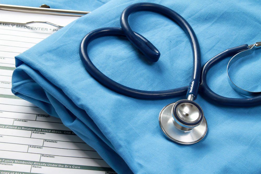 Stethoscope Shaping A Heart And A Clipboard On A Medical Uniform — Deception Bay Doctors In Deception Bay, QLD