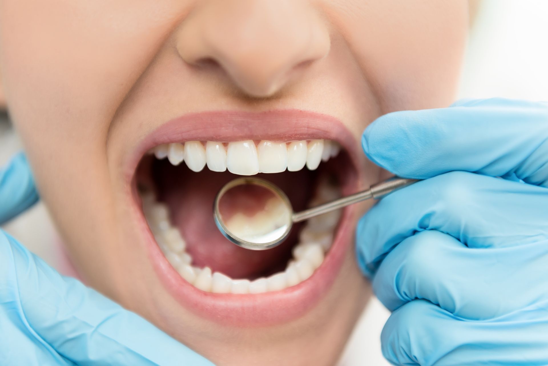 Horizontal color close-up image of young woman having dental exam