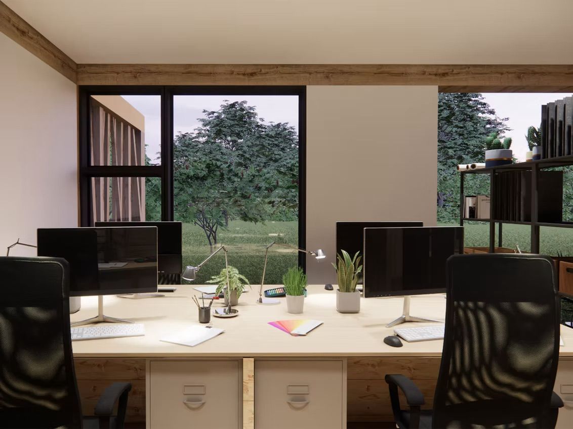 Office interior with desk, monitors, chairs, and large windows overlooking a green landscape.