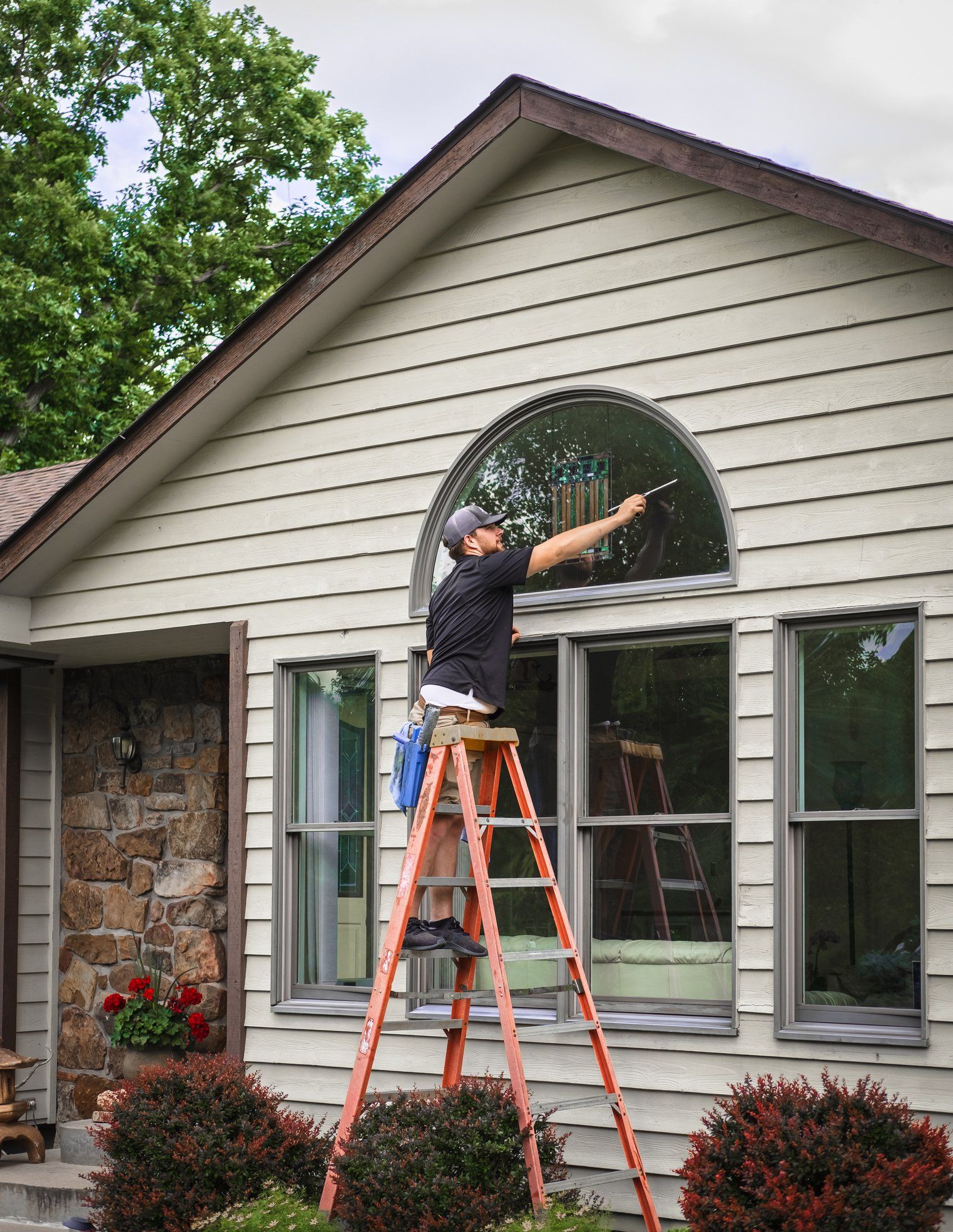 Man Cleaning Exterior Of Windows