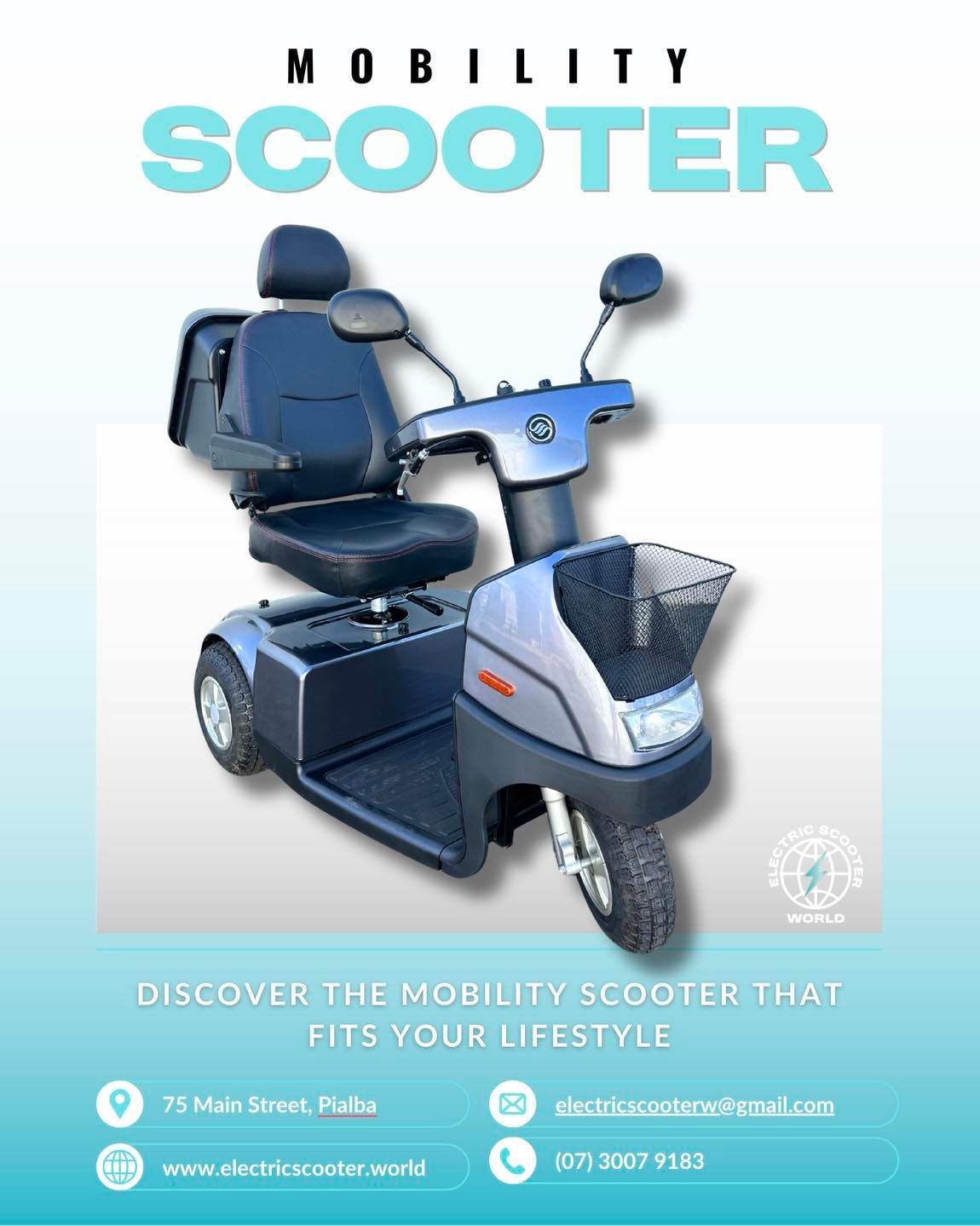 A matte black electric scooter charging at a station in front of a modern glass office building.