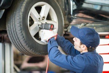 Mechanic working with tire in shop - Auto Repair Service in Logan, UT