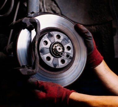 Mechanic Working on Car Brakes - Auto Repair Service in Logan, UT