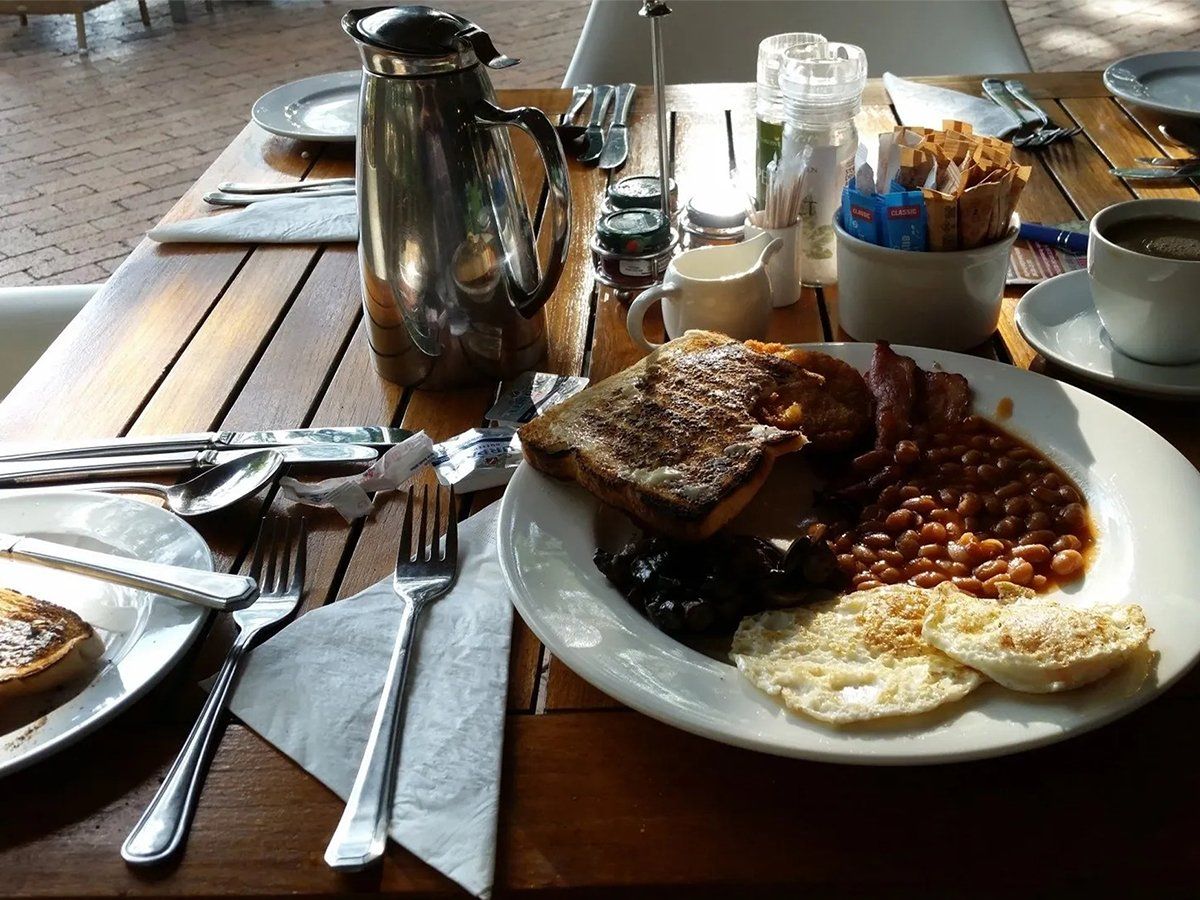 South African breakfast plate with beans, eggs, toast, and bacon.