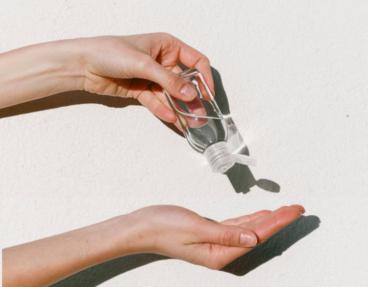 A person is pouring hand sanitizer into another person 's hand.
