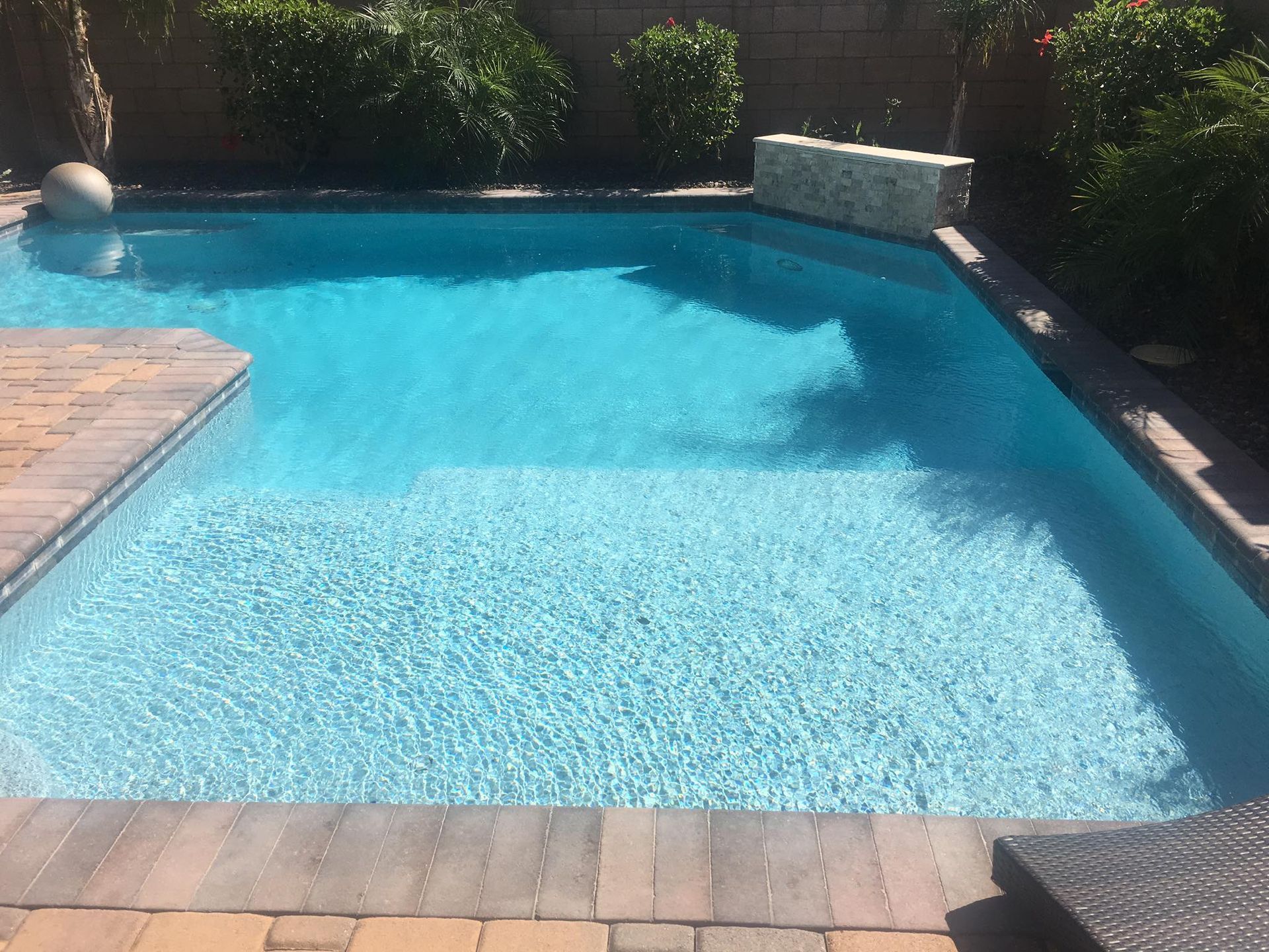 A large swimming pool with a ball in it