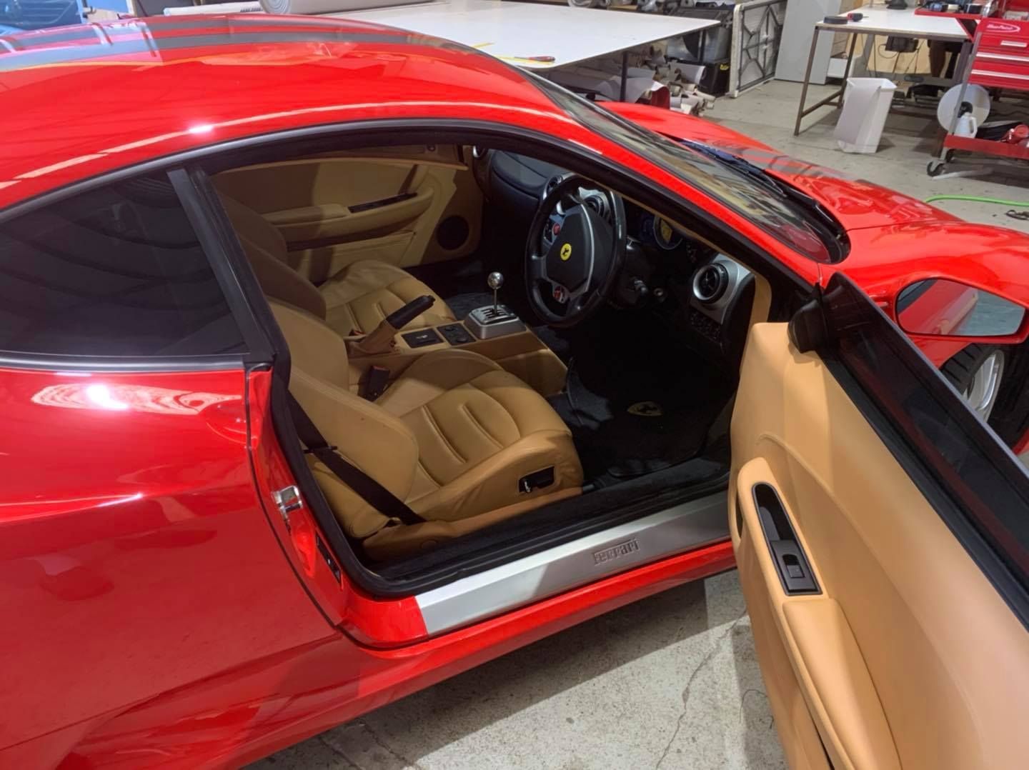 Red Ferrari sports car interior with tan leather seats — Tidy Trim Newcastle in Carrington, NSW