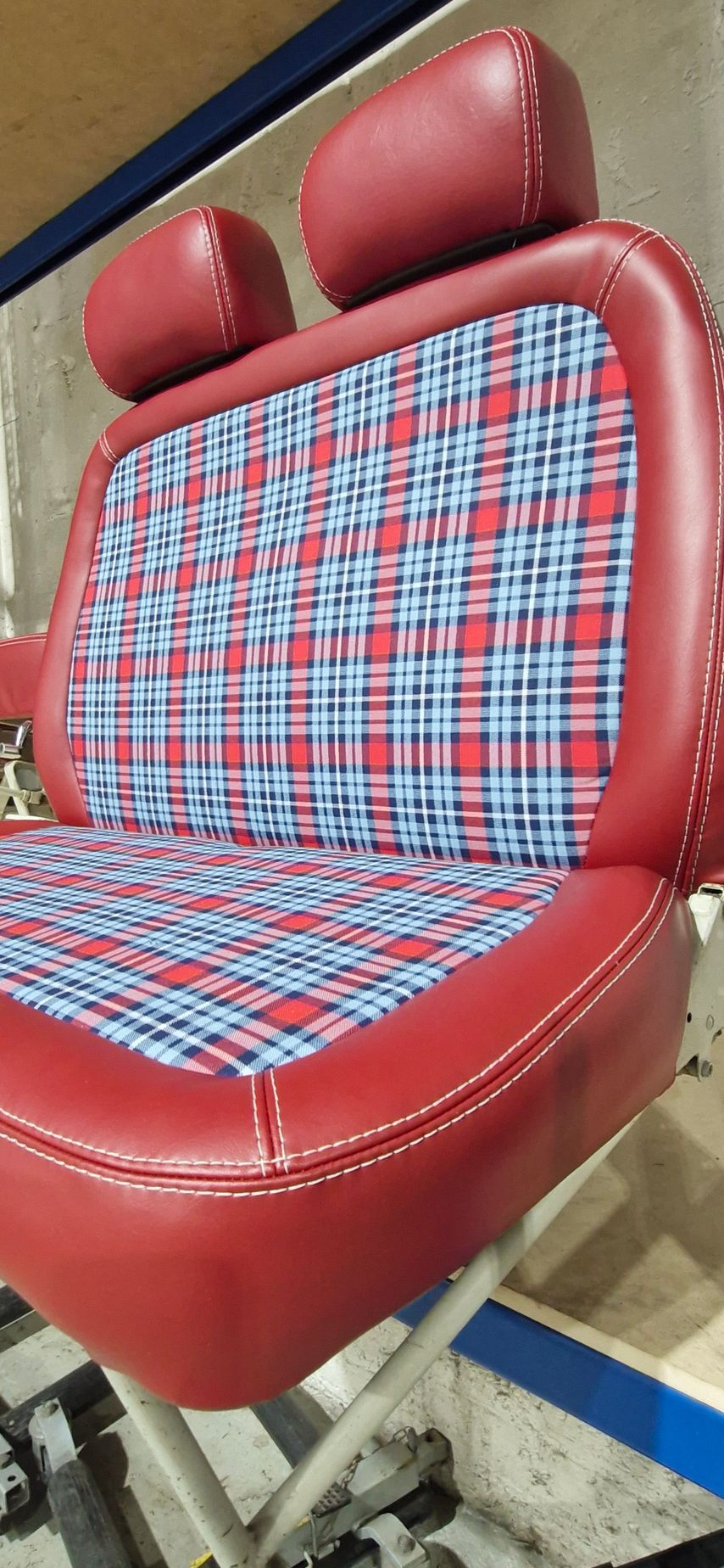 A red vinyl and plaid fabric bucket seat with two headrests — Tidy Trim Newcastle in Carrington, NSW