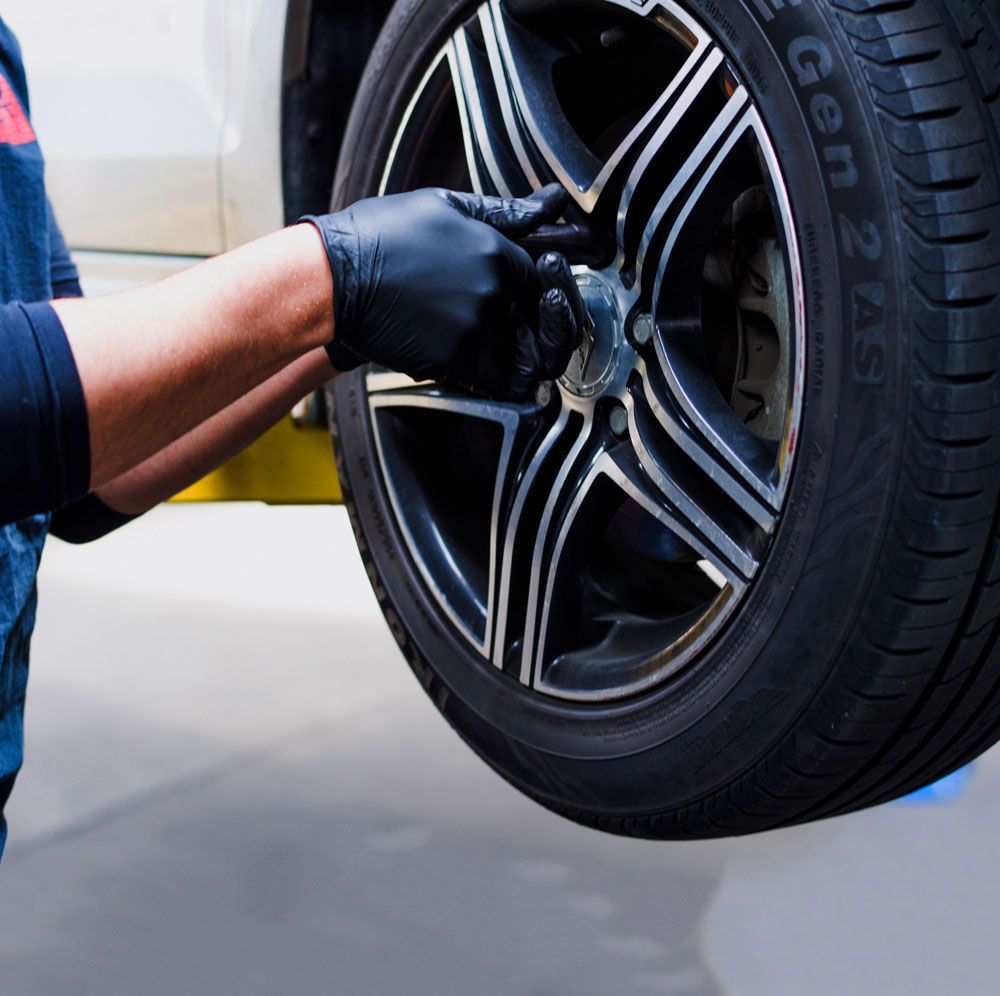 Mechanic Working With Tire | North Texas Auto Services
