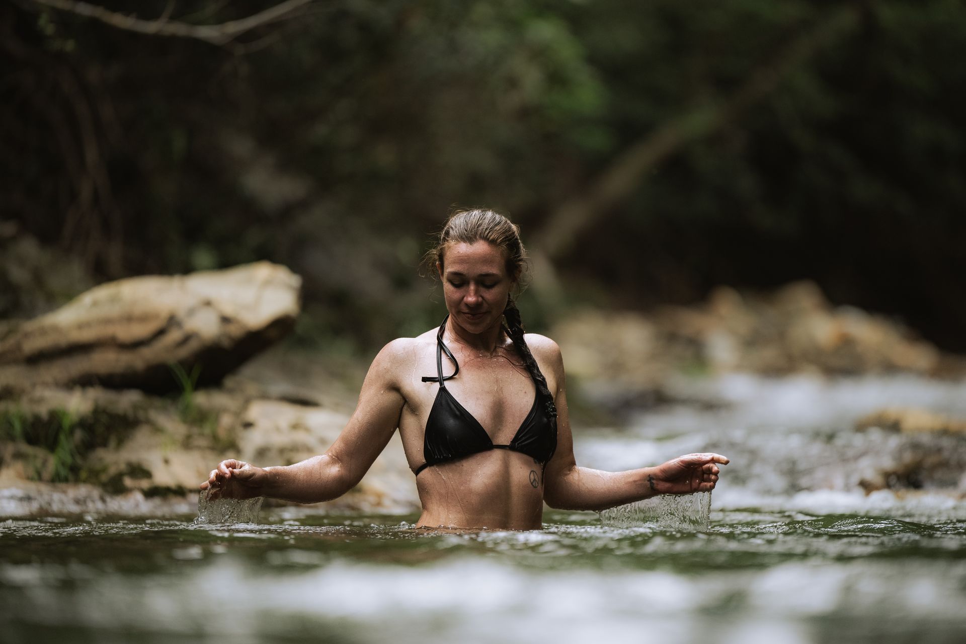 A person is soaking in a pool of natural cold water