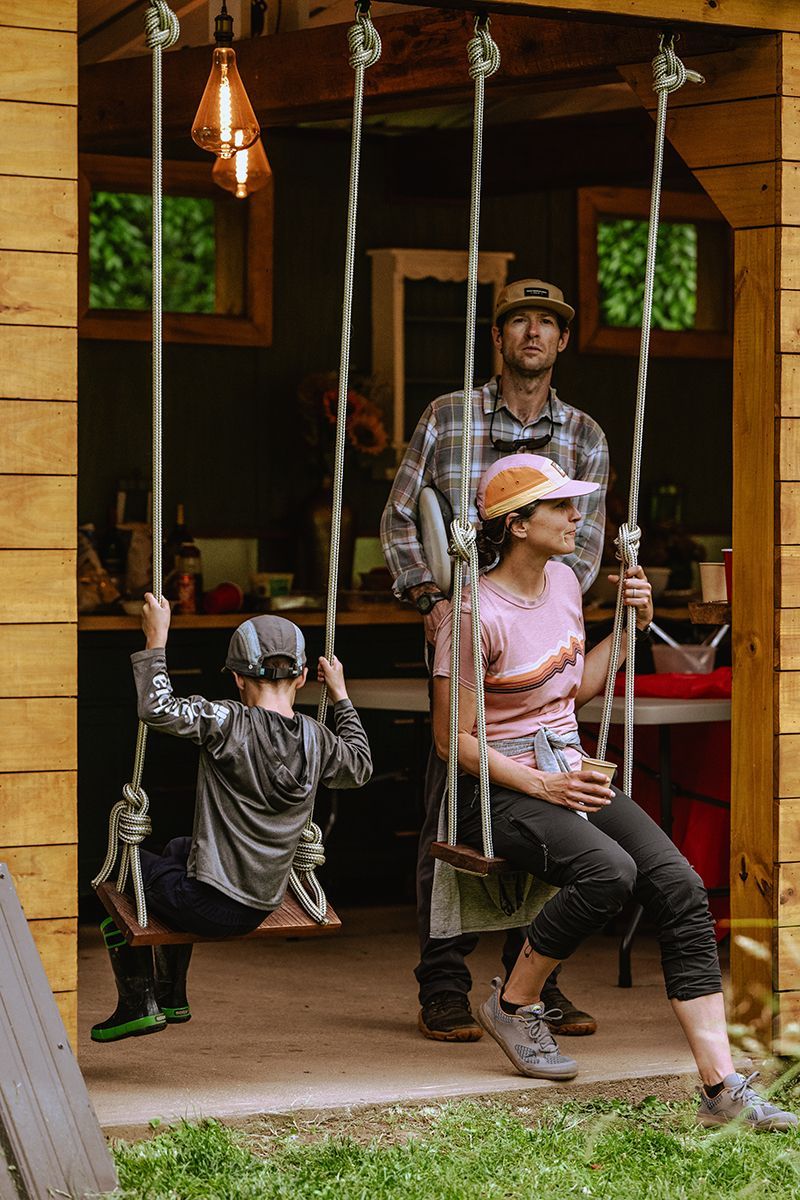 A family swings on swings made with rope.