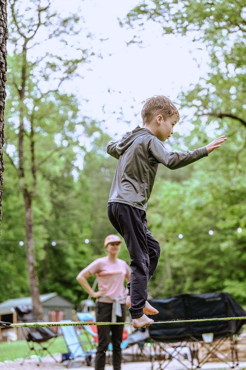 A boy balances on a slackline.