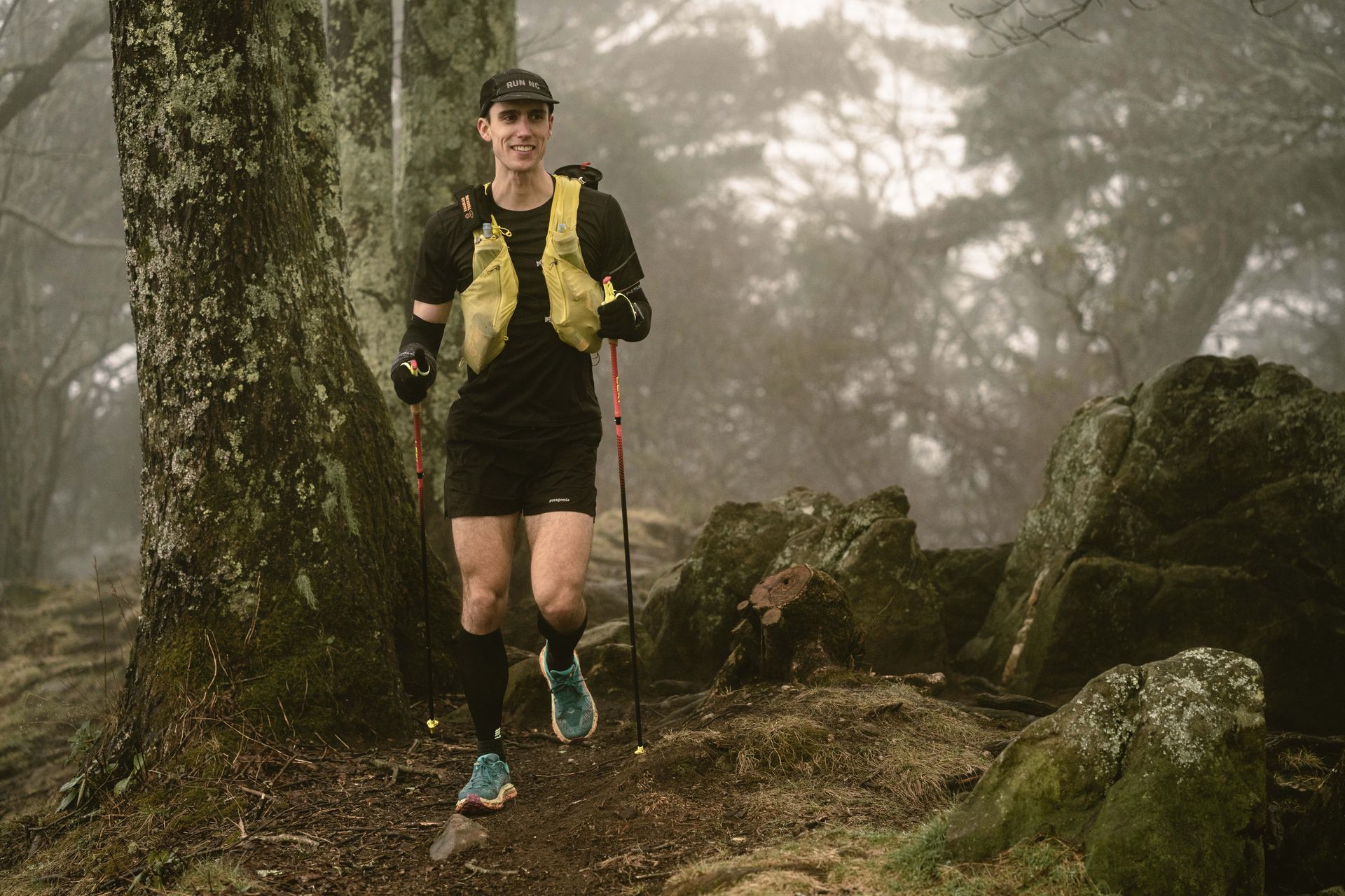 A man hikes through forest.